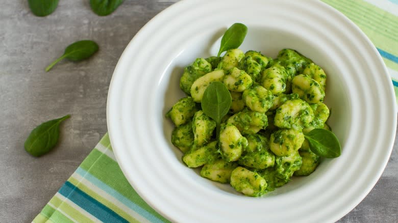 Pesto gnocchi in white bowl