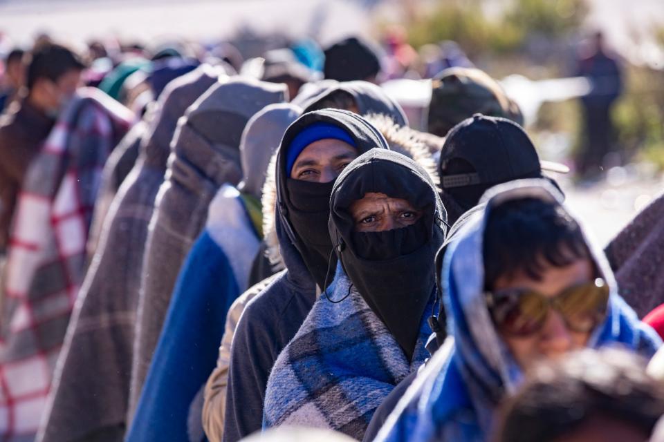 Migrants who crossed the Rio Grande from Juárez into El Paso to seek asylum brave freezing temperatures as they wait to be processed by Customs and Border Protection in December.