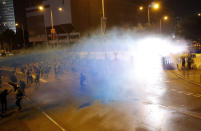 Police use water cannon to disperse protestors in Hong Kong, Saturday, Sept. 28, 2019. A pro-democracy rally in downtown Hong Kong has ended early amid sporadic violence, with police firing tear gas and a water cannon after protesters threw bricks and Molotov cocktails at government offices. (AP Photo/Vincent Thian)