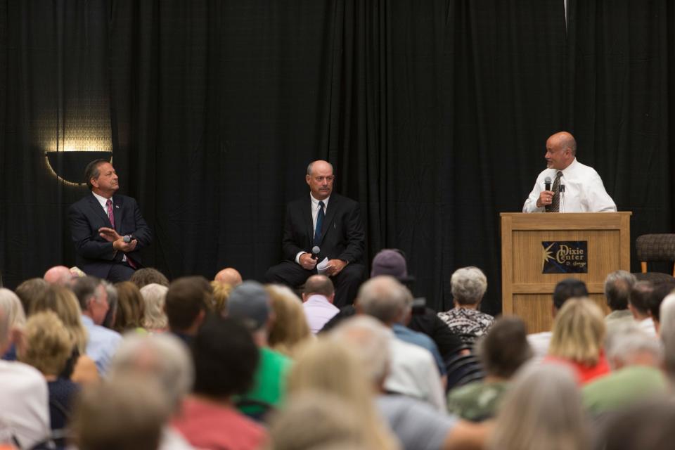 Candidates Gil Almquist, left, and Allen Davis look on as moderator Shawn Guzman speaks during a debate hosted by the Washington County Republican Party for local candidates ahead of the upcoming primary election. The debates were held at the Dixie Convention Center in St. George on Tuesday, May 17, 2022.