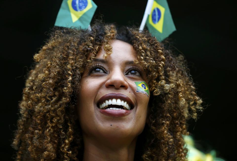 A Brazil fan smiles before the team's 2014 World Cup semi-finals against Germany at the Mineirao stadium in Belo Horizonte