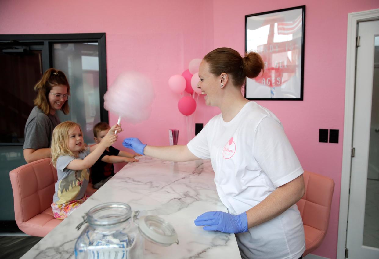 Nora Gerdmann, 4, is all smiles as she gets a grape cotton candy from owner Lexi Schmidt-Hubers at Kaukauna Cotton Candy Friday, June 21, 2024, in Kaukauna, Wisconsin. Nora was with her mother Brittany Gerdmann and brother Jack Gerdmann, 2. Kaukauna Cotton Candy is located at 139 E. Second St., Kaukauna.