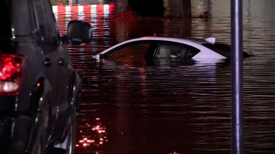 A car is seen submerged in floodwater in Rock Hill, Missouri, on April 2, 2024. - KSDK