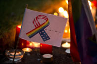 <p>A tribute message and design stands amongst candles laid at Saint Anne’s Church in the Soho district of central London, during a vigil for the victims of Sunday’s Orlando shootings at a gay nightclub in Florida, Monday June 13, 2016. (AP Photo/Matt Dunham) </p>