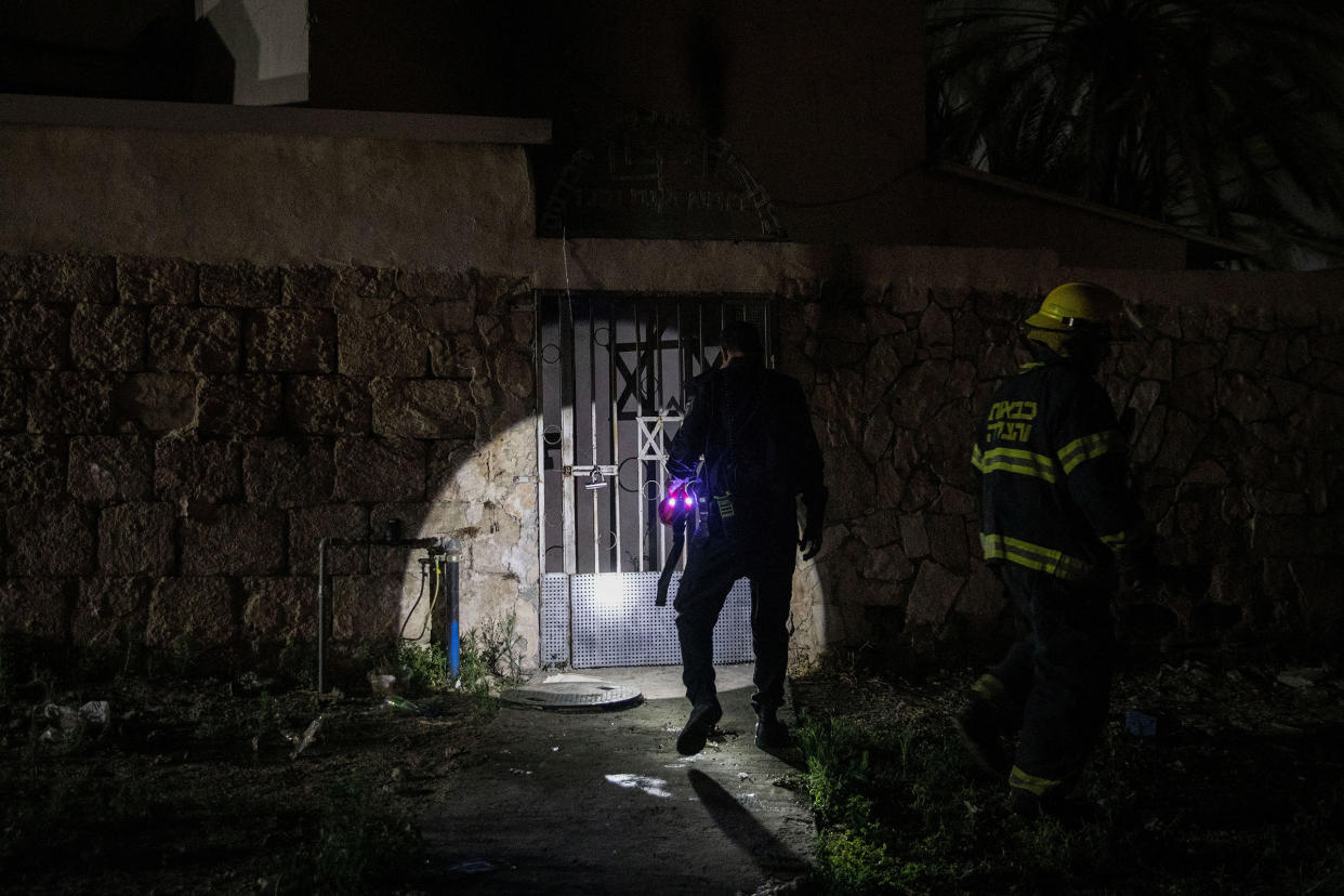 Firefighters inspect a synagogue that was set on fire during violent clashes in the mixed Arab-Jewish city of Lod, Israel, on May 14, 2021.