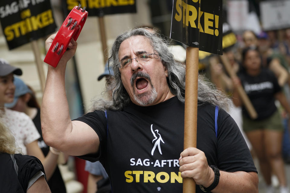 Striking writers and actors chant as they walk a picket line, Monday, July 17, 2023, in New York. Three years after the pandemic brought Hollywood to a standstill, the film and TV industry has again ground to a halt. This time, though, the industry is engaged in a bitter battle over the how streaming — after advancing rapidly during the pandemic — has upended the economics of entertainment. (AP Photo/John Minchillo)