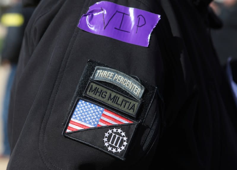 Patches are seen on the sleeve of an attendee as militia members and pro-gun rights activists participate in the "Declaration of Restoration" rally in Washington, D.C.