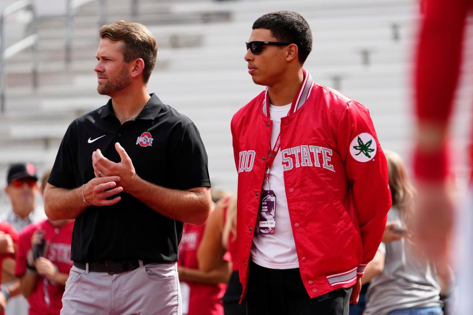 Sep 16, 2023; Columbus, Ohio, USA; Ohio State Buckeyes quarterbacks coach Corey Dennis stands with recruit Tavien St. Clair of Bellefontaine during the NCAA football game at Ohio Stadium.