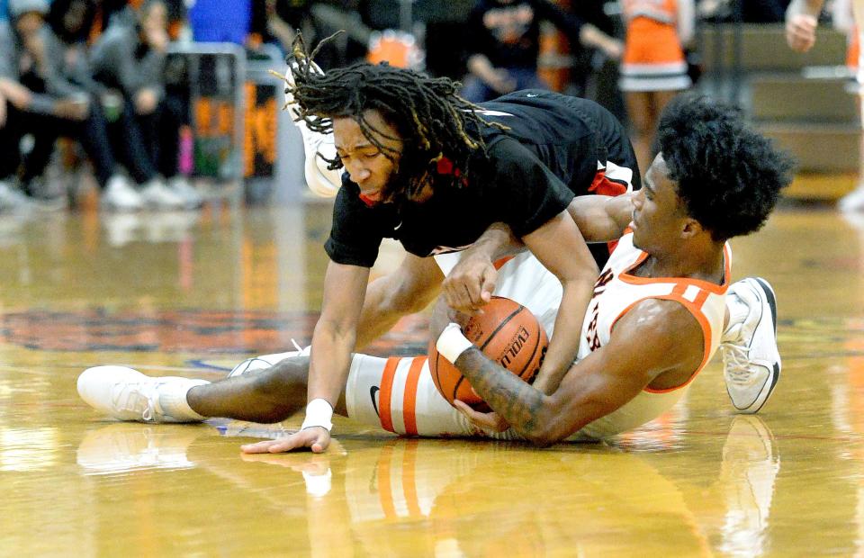 Lanphier's Jaiquan Holman, bottom, and Springfield's Jayden Jefferson fight for the ball during the game Friday, Dec. 8, 2023.