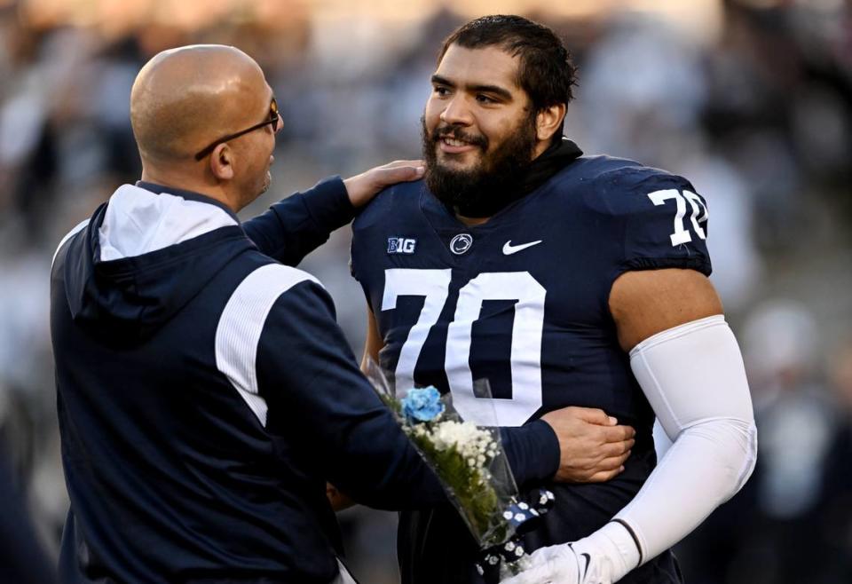 Penn State football coach James Franklin congratulates senior Juice Scruggs before the game against Michigan State on Saturday, Nov. 26, 2022.