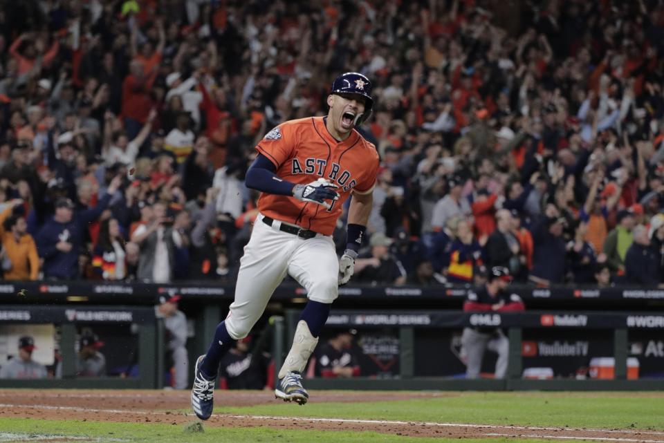 FILE - In this Oct. 30, 2019, file photo, Houston Astros' Carlos Correa reacts to his RBI single during the fifth inning of Game 7 of the baseball World Series against the Washington Nationals in Houston. The last time these teams played the Nationals were celebrating their World Series title in Houston. Since then the Astros have become the league's villains, with a sign-stealing scandal tarnishing their reputation and casting a shadow on their 2017 title. (AP Photo/David J. Phillip, File)