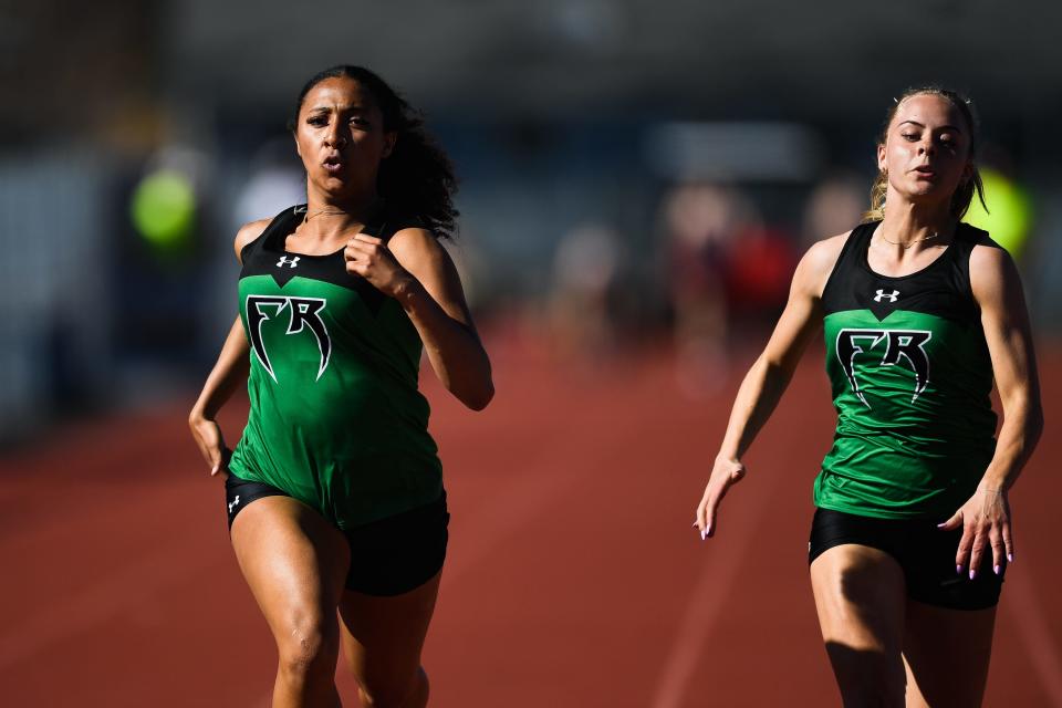 Fossil Ridge's Alexys Hill, left, and Macy Lathrop compete in the girls 100 meter dash at the Randy Yaussi City Championships at French Field on Tuesday, April 11, 2023, in Fort Collins, Colo.