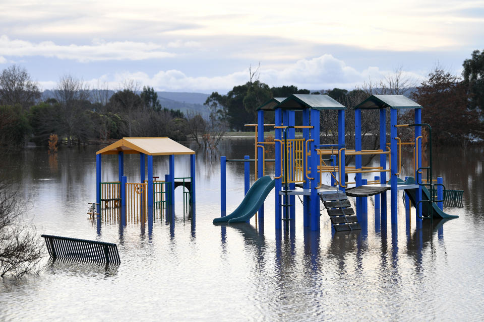 Playground equipment is seen partially submerged by floodwater in Traralgon, Victoria, Thursday, June 10. Source: AAP