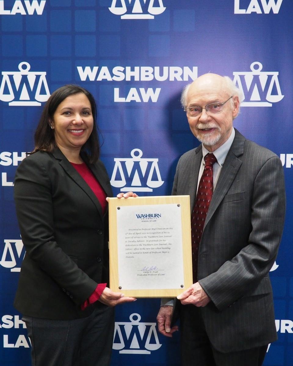 At the Washburn Law Journal's annual awards banquet, law school Dean Carla Pratt presented retiring law professor Myrl Duncan with a plaque announcing that the editor-in-chief office in the school's new building will be named in his honor.