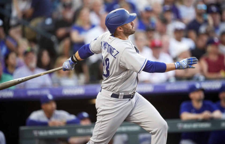 Los Angeles Dodgers' J.D. Martinez follows the flight of his solo home run against Colorado Rockies relief pitcher Brad Hand in the sixth inning of a baseball game Tuesday, June 27, 2023, in Denver. (AP Photo/David Zalubowski)