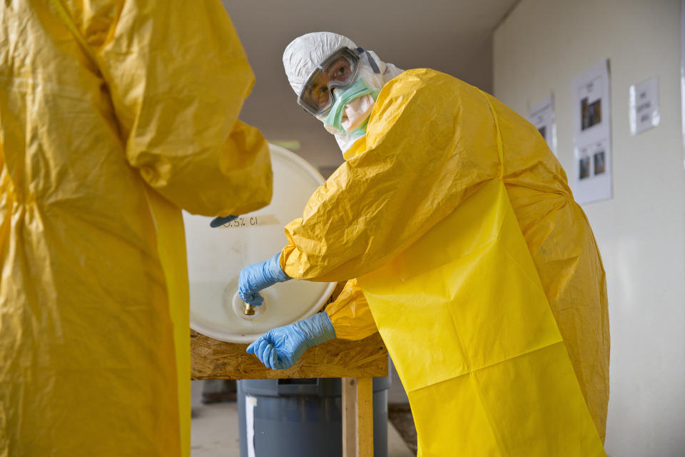 A licensed clinician sanitizes his hands after a simulated training session on Monday, Oct. 6, 2014, in Anniston, Ala. The Centers for Disease Control and Prevention (CDC) has developed an introductory training course for licensed clinicians. According to the CDC, the course is to ensure that clinicians intending to provide medical care to patients with Ebola have sufficient knowledge of the disease. (AP Photo/Brynn Anderson)