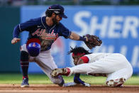Philadelphia Phillies Jean Segura (2) steals second base as Atlanta Braves shortstop Dansby Swanson (7) misses the tag during the sixth inning in Game 4 of baseball's National League Division Series, Saturday, Oct. 15, 2022, in Philadelphia. (AP Photo/Matt Rourke)