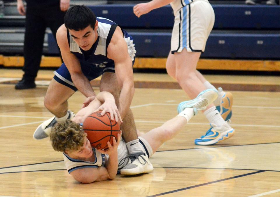 Petoskey's guard Mason Fralick (bottom) and Sault guard Kaydin Lujan wrestle for a loose ball in their matchup Tuesday night.