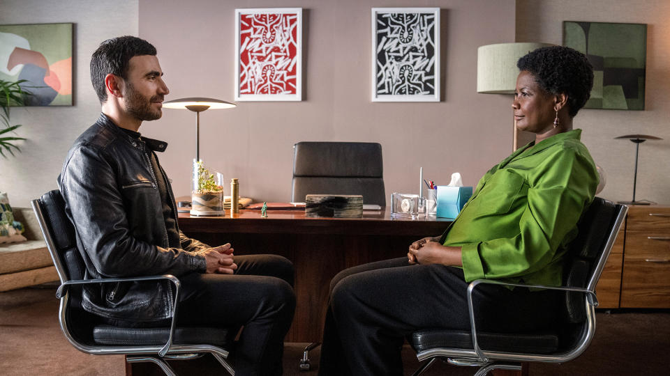 (L, R) Brett Goldstein as Roy Kent, seated and facing  Sarah Niles as Dr. Sharon Fieldstone	in Ted Lasso season 3 episode 12, 