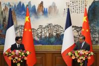 Chinese Foreign Minister Wang Yi, right, and French Foreign Minister Stephane Sejourne attend a joint press conference at the Diaoyutai State Guesthouse in Beijing, China, Monday, April 1, 2024. (Ken Ishii/Pool Photo via AP)