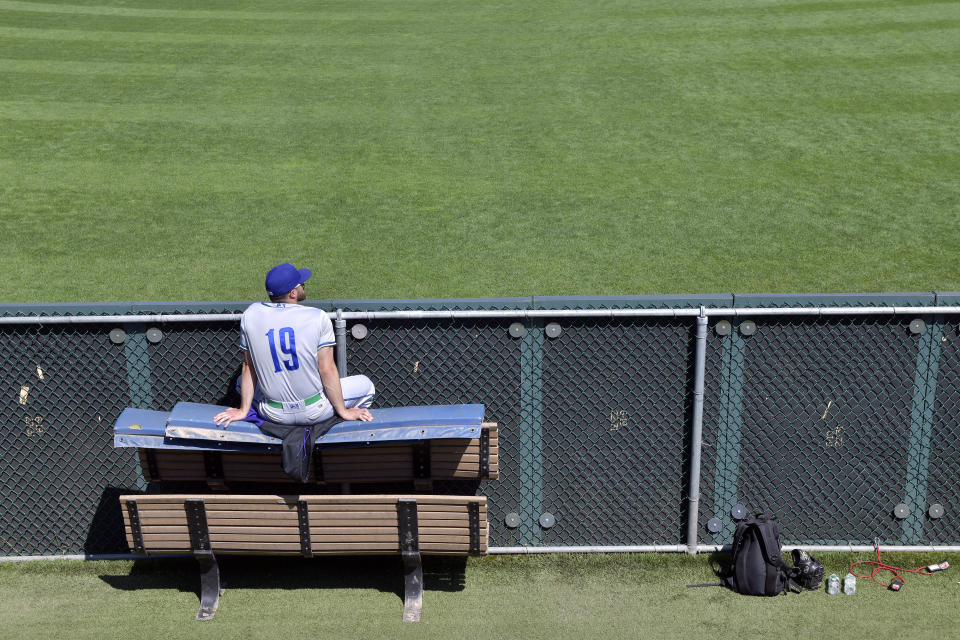 Matt Whitehouse of the Hartford Yard Goats watches from the left field wall during their game with The Portland Sea Dogs, Sunday, August 28, 2022, at Hadlock Field in Portland, Maine. Across the northeastern U.S., outdoor businesses are profiting from the unusually dry weather. (AP Photo/Josh Reynolds)