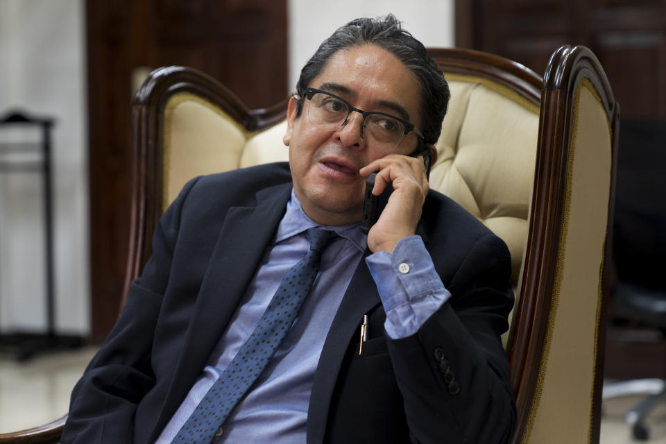 Guatemalan Ombudsman Jordan Rodas talks with one of his deputies on the phone, during an interview, days before to leaves office due to his term coming to an end, in Guatemala City, Wednesday, Aug. 17, 2022. (AP Photo/Moises Castillo)