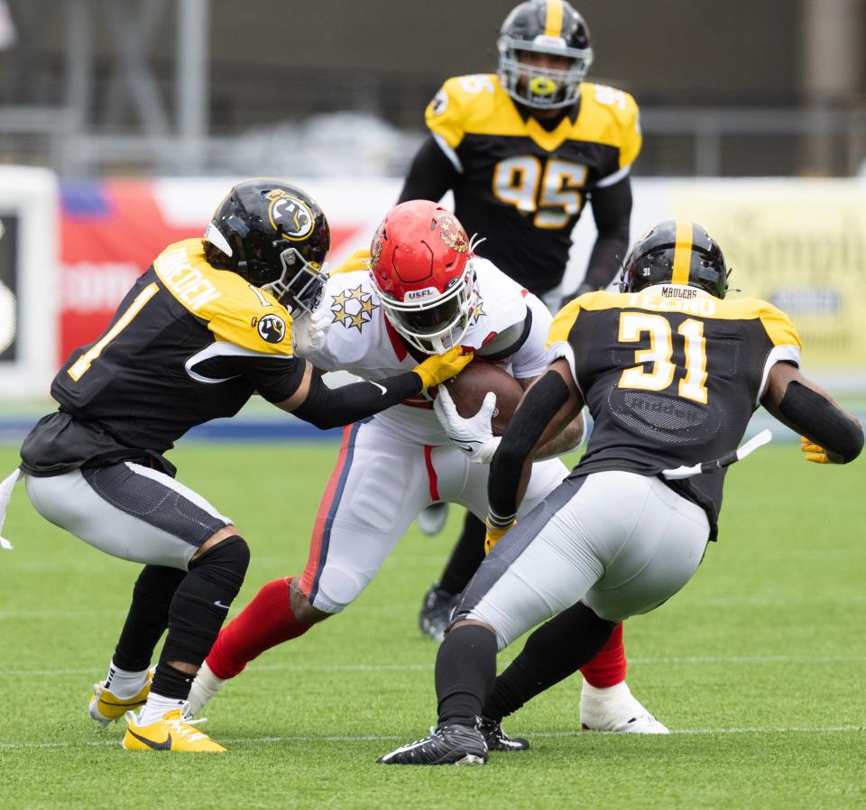 Maulers defenders swarm a ball carrier in their game vs. the Generals at Tom Benson Hall of Fame Stadium, Sunday, April 23, 2023.