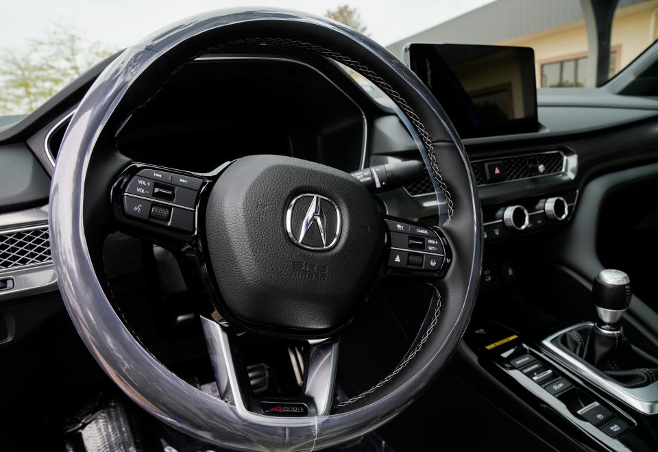 The steering wheel on the new 2023 Acura Integra A-Spec.