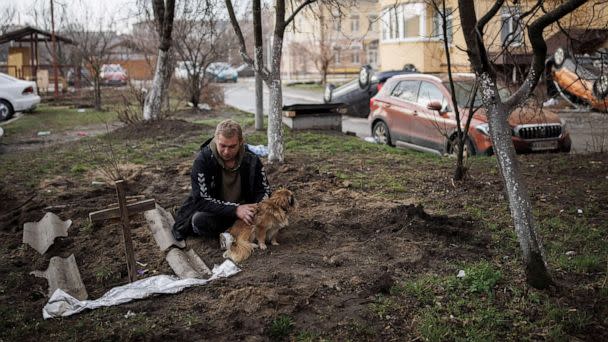 PHOTO: Serhii Lahovskyi, 26, mourns next to the grave of his friend Ihor Lytvynenko, who according to residents was killed by Russian soldiers, after they found him beside a building's basement, in Bucha, Ukraine, April 6, 2022. (Alkis Konstantinidis/Reuters)