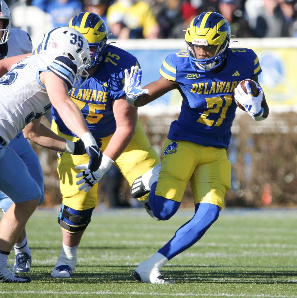 Delaware's Marcus Yarns (21) tries to fend off Villanova's Brendan Bell in the first quarter of the Blue Hens' 35-7 loss at Delaware Stadium, Saturday, Nov. 18, 2023.