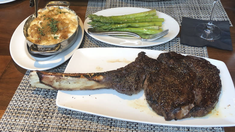 large steak asparagus white plates