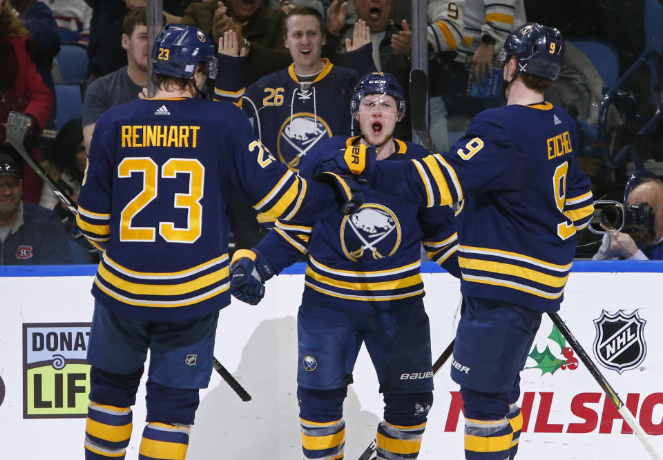 Buffalo Sabres' Sam Reinhart (23), Jeff Skinner and Jck Eichel (9) celebrate a goal during the third period of the team's NHL hockey game against the Montreal Canadiens, Friday, Nov. 23, 2018, in Buffalo N.Y. (AP Photo/Jeffrey T. Barnes)
