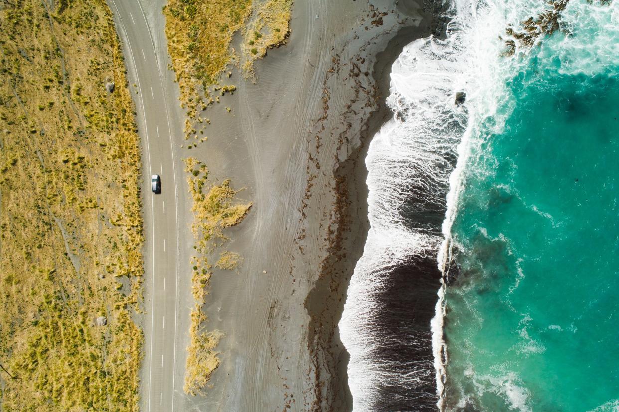 Top view of sea, waves and road in Wairarapa Region, North Island, New Zealand.