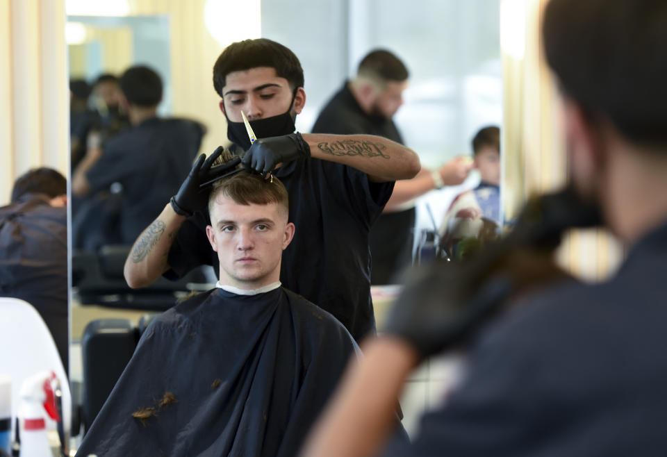 Reading, PA - June 15: Student Joel Sotelo gives a haircut to Cameron Gieringer. At the American Barber and Beauty Academy on Lancaster Ave in Reading Tuesday morning June 15, 2021. (Photo by Ben Hasty/MediaNews Group/Reading Eagle via Getty Images)