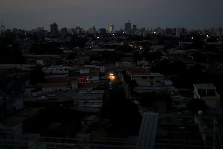 FILE PHOTO: Car's headlights are seen in a neighbourhood during a blackout, in Maracaibo, Venezuela, April 12, 2019. REUTERS/Ueslei Marcelino