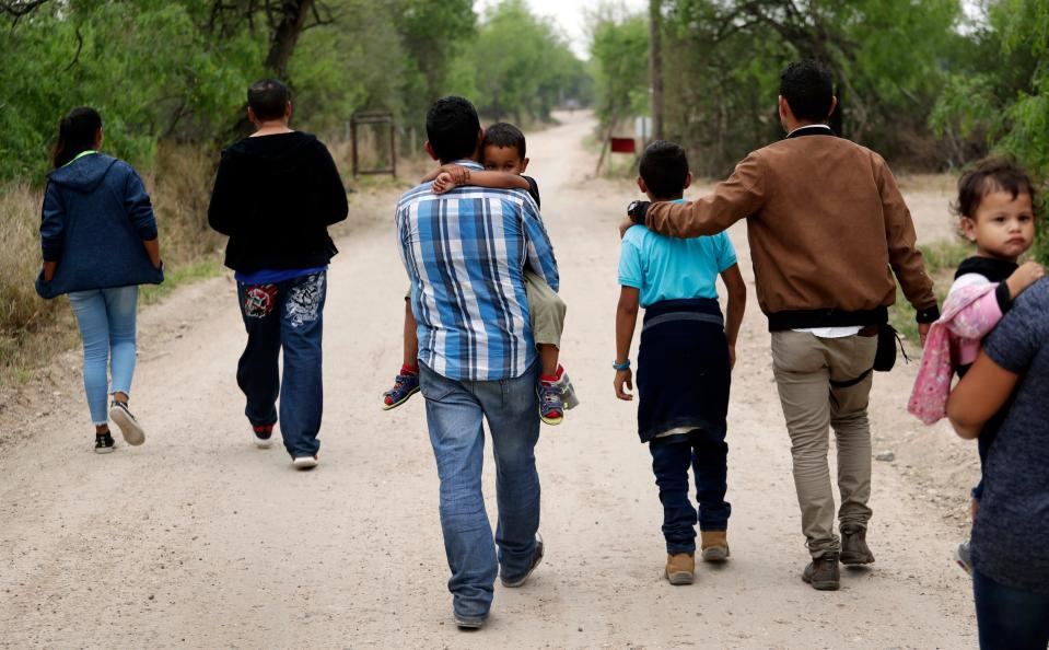 A group of migrant families walks from the Rio Grande, the river separating the U.S. and Mexico in Texas, near McAllen, Texas, March 14, 2019. A Biden administration effort to reunite children and parents who were separated under then-President Donald Trump's zero-tolerance border policy has made increasing progress as it nears the end of its first year. The Department of Homeland Security planned on Dec. 23, 2021, to announce that 100 children, mostly from Central America, are back with their families and about 350 more reunifications are in process after it adopted measures to enhance the program.