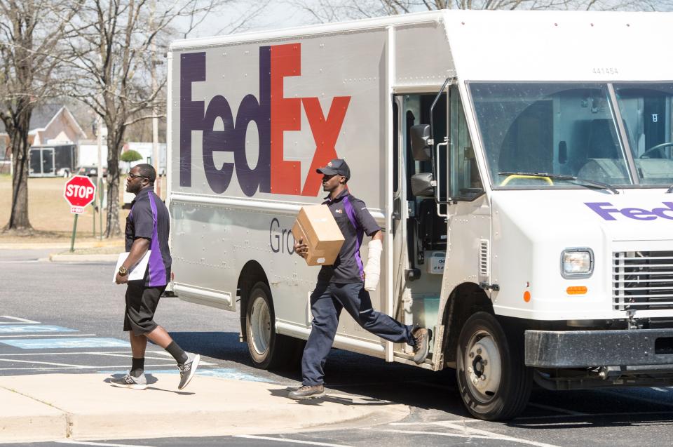 FedEx delivery men make a delivery in North Augusta, S.C.., on Tuesday, March 9, 2021. Increased reliance on home deliveries has been a hallmark of living under COVID-19 restrictions.