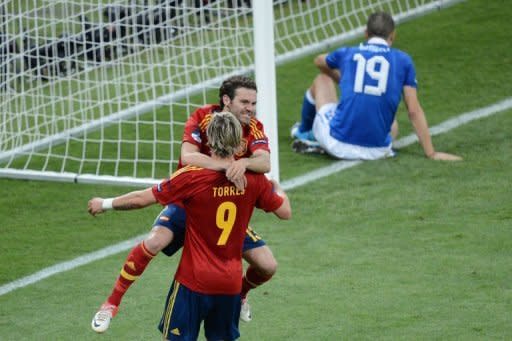 Spain forward Fernando Torres celebrates with teammate Juan Mata after scoring after 84 minutes of the Euro 2012 football championships final match against Italy at the Olympic Stadium in Kiev on July 1. Spain won 4-0