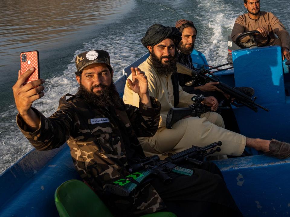 Taliban fighters take a selfie while enjoying a boat ride in Afghanistan