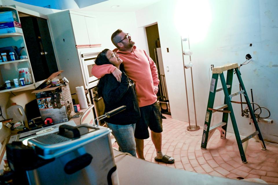 Jennie Shire, left, and Sam Postema stand in the gutted kitchen of their UFO-shaped home on Wednesday, Sept. 27, 2023, in DeWitt Township. The couple are updating the unique home.