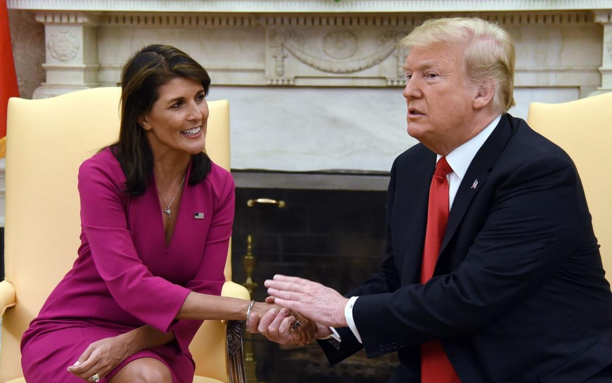 TOPSHOT - US President Donald Trump shakes hands with Nikki Haley, the United States Ambassador to the United Nations in the Oval office of the White House on October 9, 2018 in Washington, DC. - Nikki Haley resigned Tuesday as the US ambassador to the United Nations, in the latest departure from President Donald Trump's national security team. Meeting Haley in the Oval Office, Trump said that Haley had done a "fantastic job" and would leave at the end of the year.  - Olivier Douliery/AFP via Getty Images