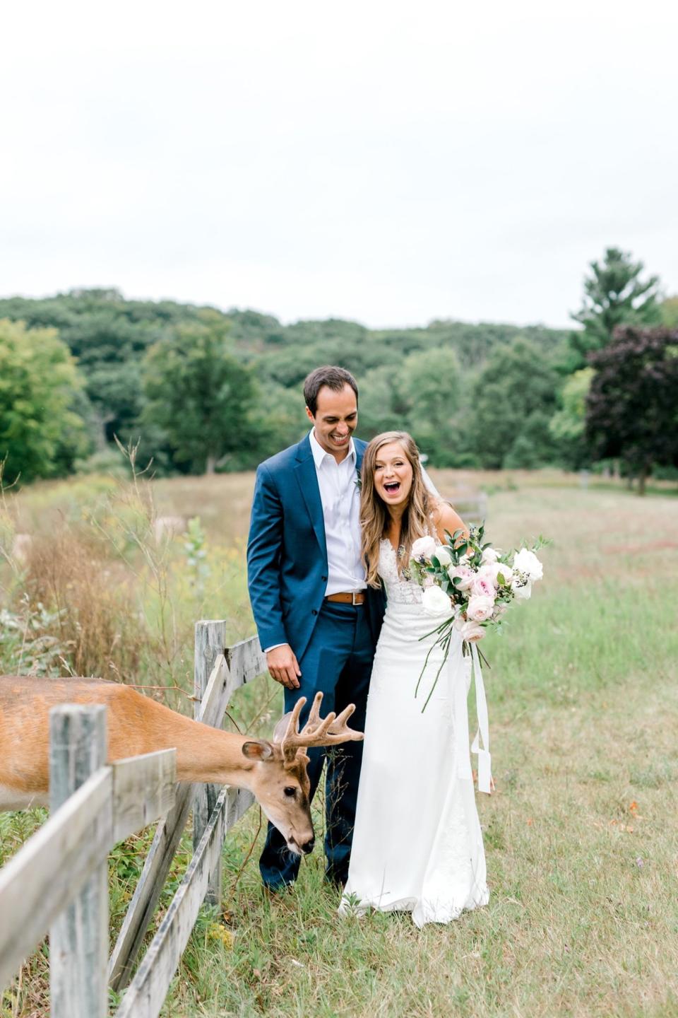 After their wedding ceremony, Luke and Morgan Mackley got to pose with a local deer, much to their amusement. (Photo: Laurenda Marie Photography)