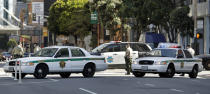 Law enforcement officers close Howard Street to vehicular traffic as activists protest outside Moscone Center on Friday, April 3, 2020, in San Francisco. (AP Photo/Ben Margot)