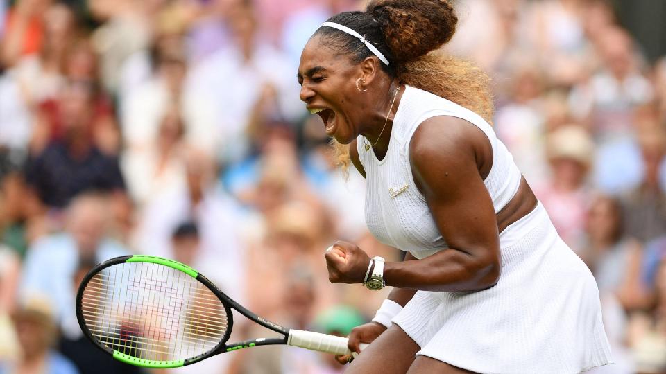 Serena Williams holding a racquet and celebrating 