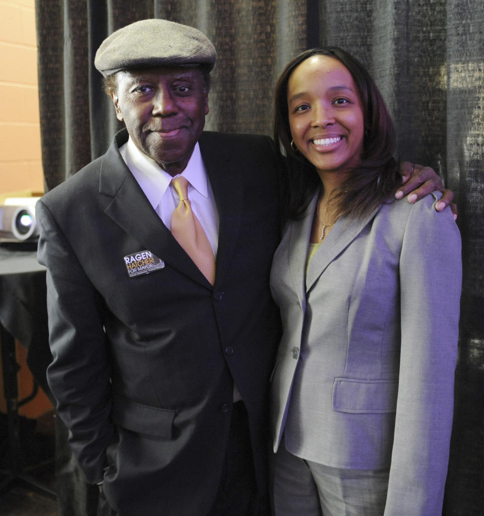 FILE - In this April 17, 2011 file photo, Gary, Ind., mayoral candidate Ragen Hatcher poses for a photo with her father, former Gary Mayor Richard Hatcher, prior to a election forum held in downtown Gary. On Friday, Dec. 13, 2019, Hatcher, who became one of the first black mayors of a big U.S. city when he was elected in 1967, died. He was 86. (AP Photo/Joe Raymond)