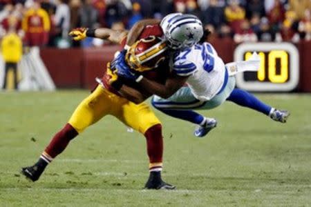 Washington Redskins running back Chris Thompson (25) is tackled by Dallas Cowboys free safety J.J. Wilcox (27) in the fourth quarter at FedEx Field. The Cowboys won 19-16. Mandatory Credit: Geoff Burke-USA TODAY Sports