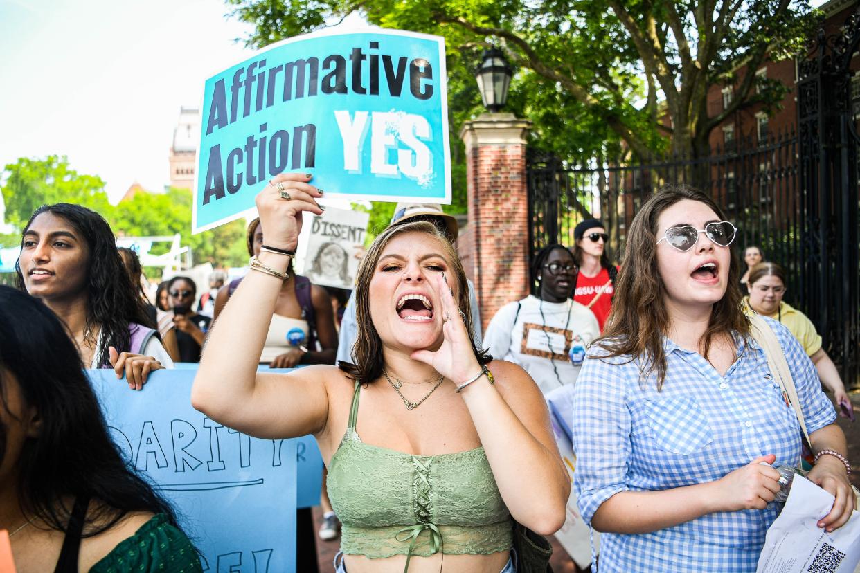 Participants march and chant slogans at a rally protesting the Supreme Court's ruling against affirmative action 