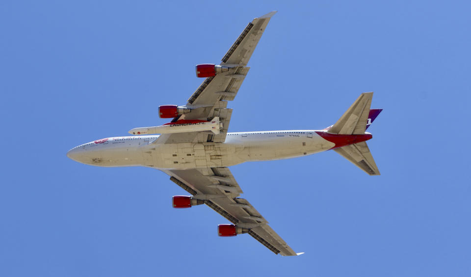 A Virgin Orbit Boeing 747-400 aircraft named Cosmic Girl takes off from Mojave Air and Space Port in the desert north of Los Angeles Monday, May 25, 2020. Richard Branson's Virgin Orbit failed Monday in its first test launch of a new rocket carried aloft by the Boeing 747 and released over the Pacific Ocean off the coast of Southern California. (AP Photo/Matt Hartman)