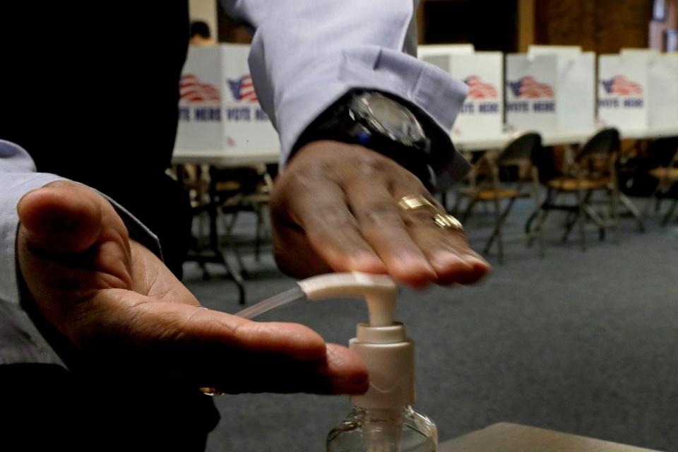 A man uses hand sanitizer after voting in the presidential primary election at the the Summit View Church of the Nazarene on March 10 in Kansas City, Mo. The polling place served two precincts as voters who were scheduled to vote at a nearby senior living facility were directed to vote at the church after the facility backed out due to coronavirus concerns.