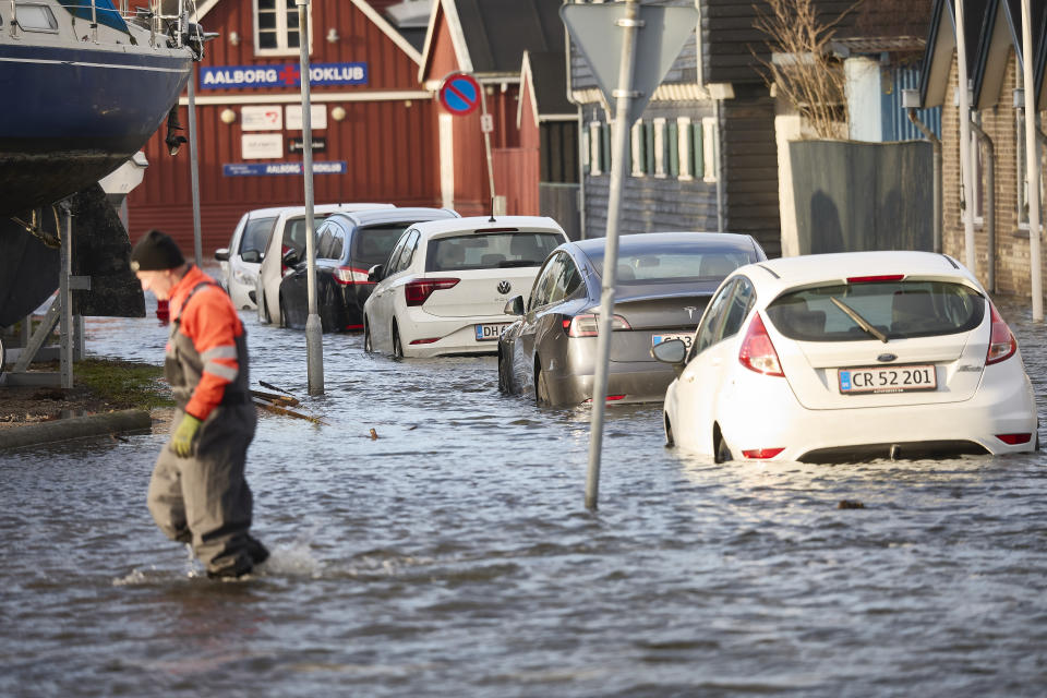 Cars stand in water on the Aalborg harbor front, North Jutland, Denmark, Friday Dec. 22, 2023. The water is rising in the Limfjorden after storm Pia blew over the country on Thursday. (Claus Bjoern Larsen/Ritzau Scanpix via AP)